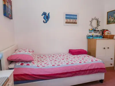 a small bedroom with a bed and a dresser at Greystones in Newton Stewart