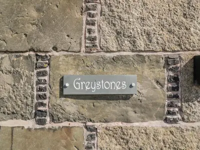 a sign that says gyroscopes on a stone wall at Greystones in Newton Stewart