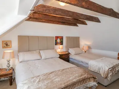two beds in a room with white walls at Greystones in Newton Stewart