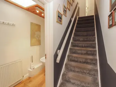 a staircase in a home with a skylight at Riverside Cottage in Cockermouth
