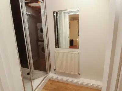a bathroom with a glass shower and a mirror at Riverside Cottage in Cockermouth