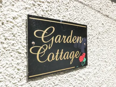 a sign for a garden exchange on the side of a building at Garden Cottage in Castle Douglas