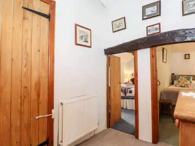 an open door to a bedroom with a bed at Castle Lodge in Keswick