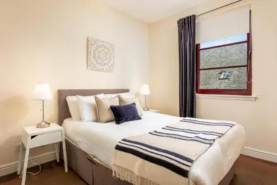 a bedroom with a large bed and a window at Elliot Suite No15 - Donnini Apartments in Ayr