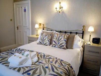 a bedroom with a bed with two towels on it at Link House in Bassenthwaite Lake