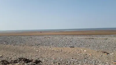 a beach with rocks and the ocean in the background at 27 The Beeches, Gilcrux, Nr Cockermouth, Cumbria in Gilcrux
