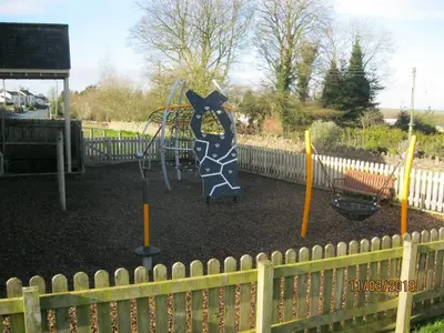 a playground with a dog on a swing at 27 The Beeches, Gilcrux, Nr Cockermouth, Cumbria in Gilcrux