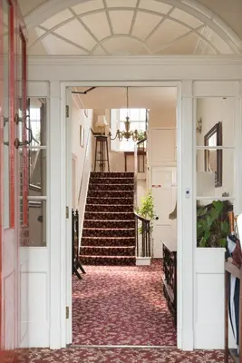 an open hallway with stairs in a house at Acorn House in Keswick