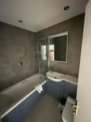 a bathroom with a tub and a sink and a toilet at Three Shires Inn in Little Langdale