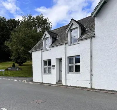 a white house on the side of a street at Stanger Cottage in Keswick