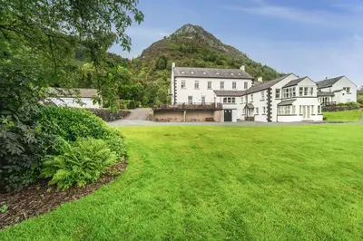 an exterior view of a house with a green lawn at Lords Seat in Keswick