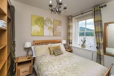 a bedroom with a bed and a window at Lords Seat in Keswick