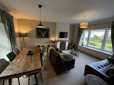 a living room with a table and a couch at Lords Seat in Keswick