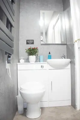 a bathroom with a white toilet and a sink at Barns Serviced Accommodation in Ayr