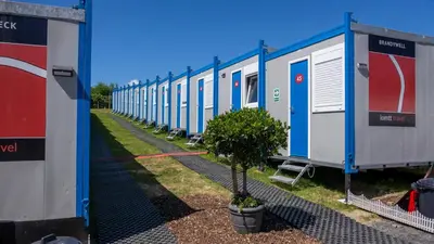 a row of mobile homes parked next to each other at IOMTT Village at Isle of Man TT in Douglas
