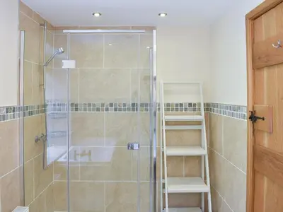 a bathroom with a shower with a glass door at Hovera in Glenridding