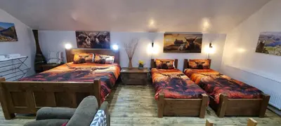 a bedroom with two beds and a couch at Windsor Cottage on The Big 