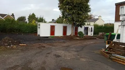 a house with red doors in a yard at The Townhouse Self Catering in Dumfries