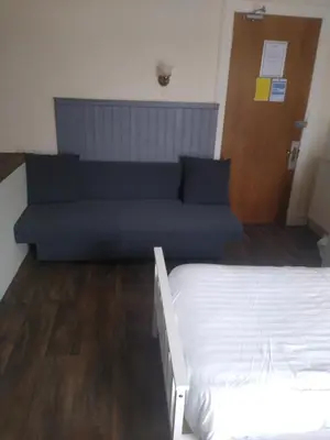 a living room with a couch and a bed at The Townhouse Self Catering in Dumfries