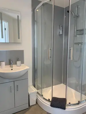 a bathroom with a shower and a sink at The Bungalows Guesthouse in Threlkeld