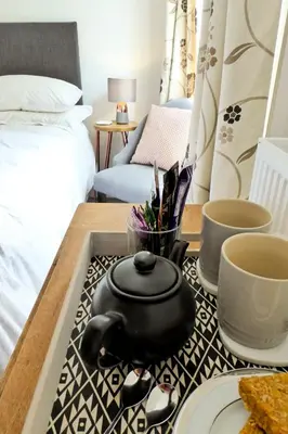 a tea pot on a tray on a table in a bedroom at Rosalind House in Carlisle