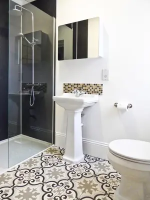 a white bathroom with a sink and a shower at Rosalind House in Carlisle