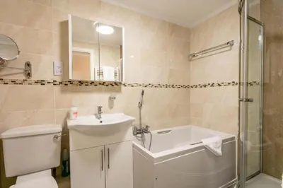 a bathroom with a toilet and a sink and a shower at Arran View - Coorie Doon Stays in Ayr