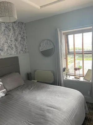 a bedroom with a bed and a window at Dove cottage in Allonby