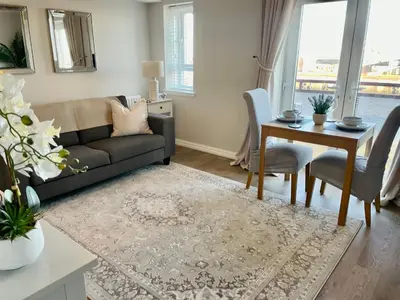 a living room with a couch and a table at Kintyre Apartment in Ayr