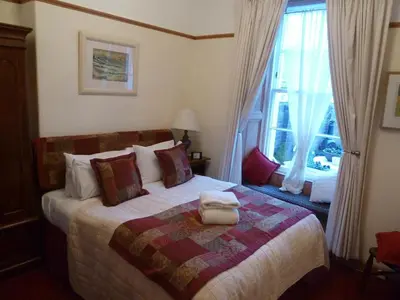 a bedroom with a bed and a window at Burnside Guest House in Ayr