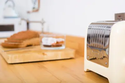 a toaster sitting on a counter with a loaf of bread at The Nook Cottage in Carlisle