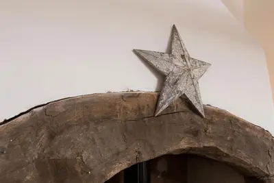 a star sitting on top of a wooden arch at The Nook Cottage in Carlisle