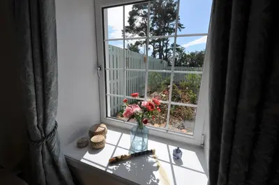 a vase of flowers sitting on a window sill at No 1 Ramageton at Carnell Estates in Hurlford