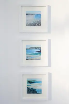 a group of four framed paintings on a wall at Marina View Guest House in Irvine