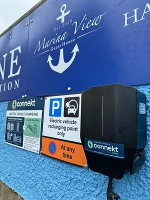 a parking meter with signs on the side of a building at Marina View Guest House in Irvine