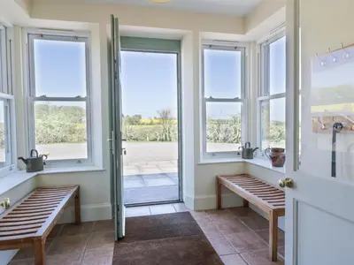 a room with windows and benches and a door at Marl House in Newton Stewart