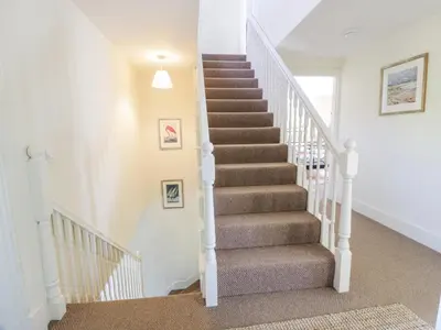 a staircase in a home with white railings at Marl House in Newton Stewart