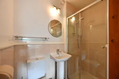a bathroom with a toilet and a sink and a shower at Lochans Lodge in Stranraer