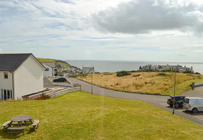 a view of the ocean from a house at The Fairways in Portpatrick