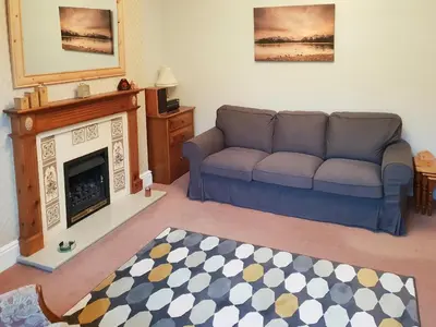 a living room with a couch and a fireplace at Robinson in Keswick