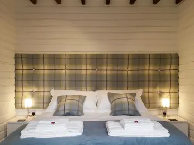 a bedroom with a bed with two towels on it at Field House Lodge in Borrowdale Valley