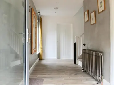 a hallway with white walls and a tile floor at Ramerish Retreat in Laurieston