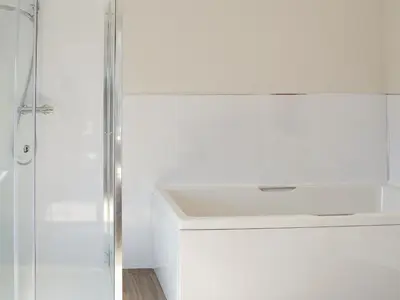 a white bathroom with a shower and a sink at Smithfield House in Tarbolton