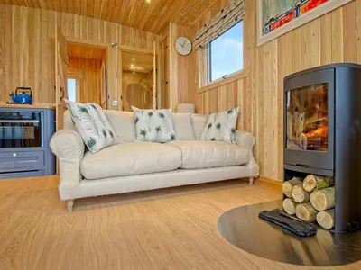 a living room with a couch and a fireplace at Little Oak - Uk5996 in Carsluith