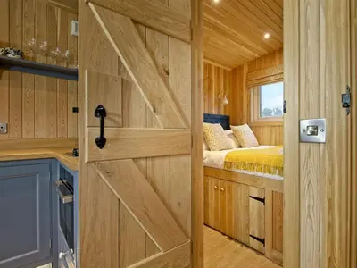 a sliding barn door in a tiny house at Little Oak - Uk5996 in Carsluith