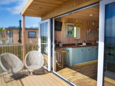 a view of a kitchen from the balcony of a tiny house at Little Willow - Uk5998 in Carsluith