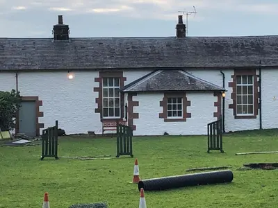 an old building with a cannon in front of it at The Annex, countryside escape in Dumfries