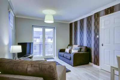 a living room with a couch and a window at No 7 Ayr Beach - Coorie Doon in Ayr