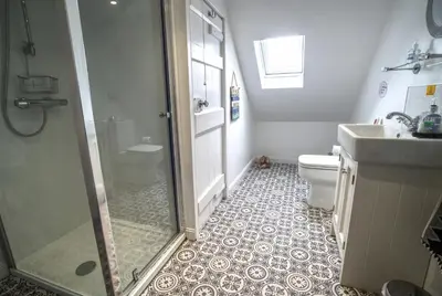 a bathroom with a shower and a toilet and a sink at The View in Garlieston