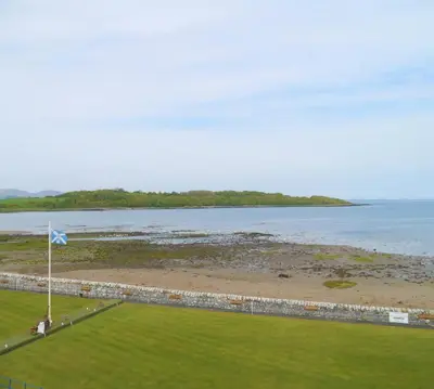 an aerial view of a beach with a flag at The View in Garlieston
